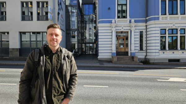 Smilende mann i bylandskap